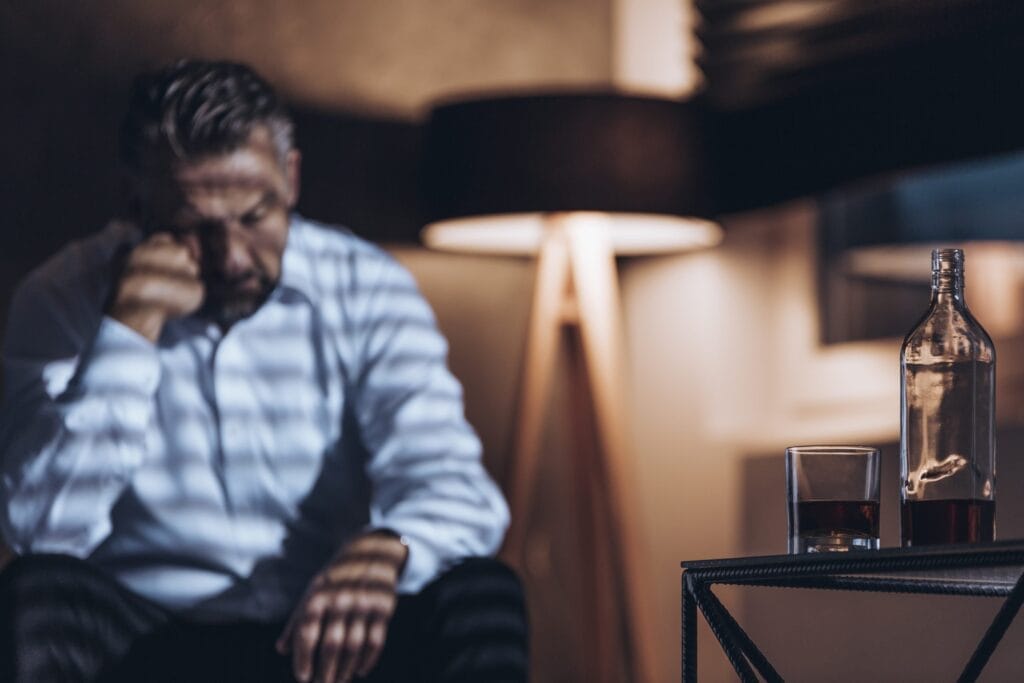 bottle and glass with alcohol in the foreground an HJYMV49 scaled 1