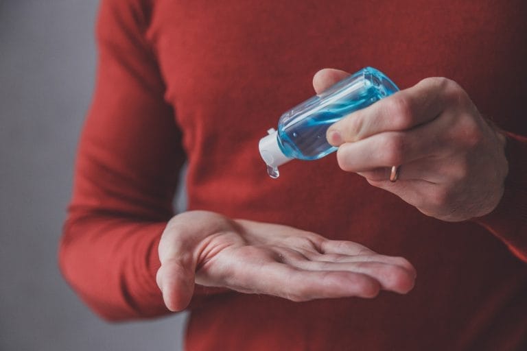 man using wash hand sanitizer gel dispenser FFPZ4FC 768x512 1